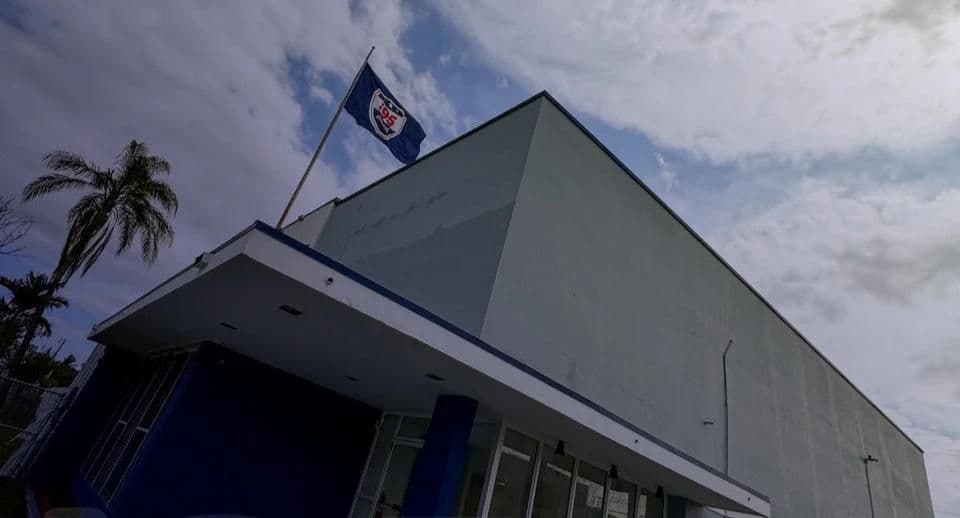 i95 Padel, 650 NW 105th Street, Miami — the club flag over the building